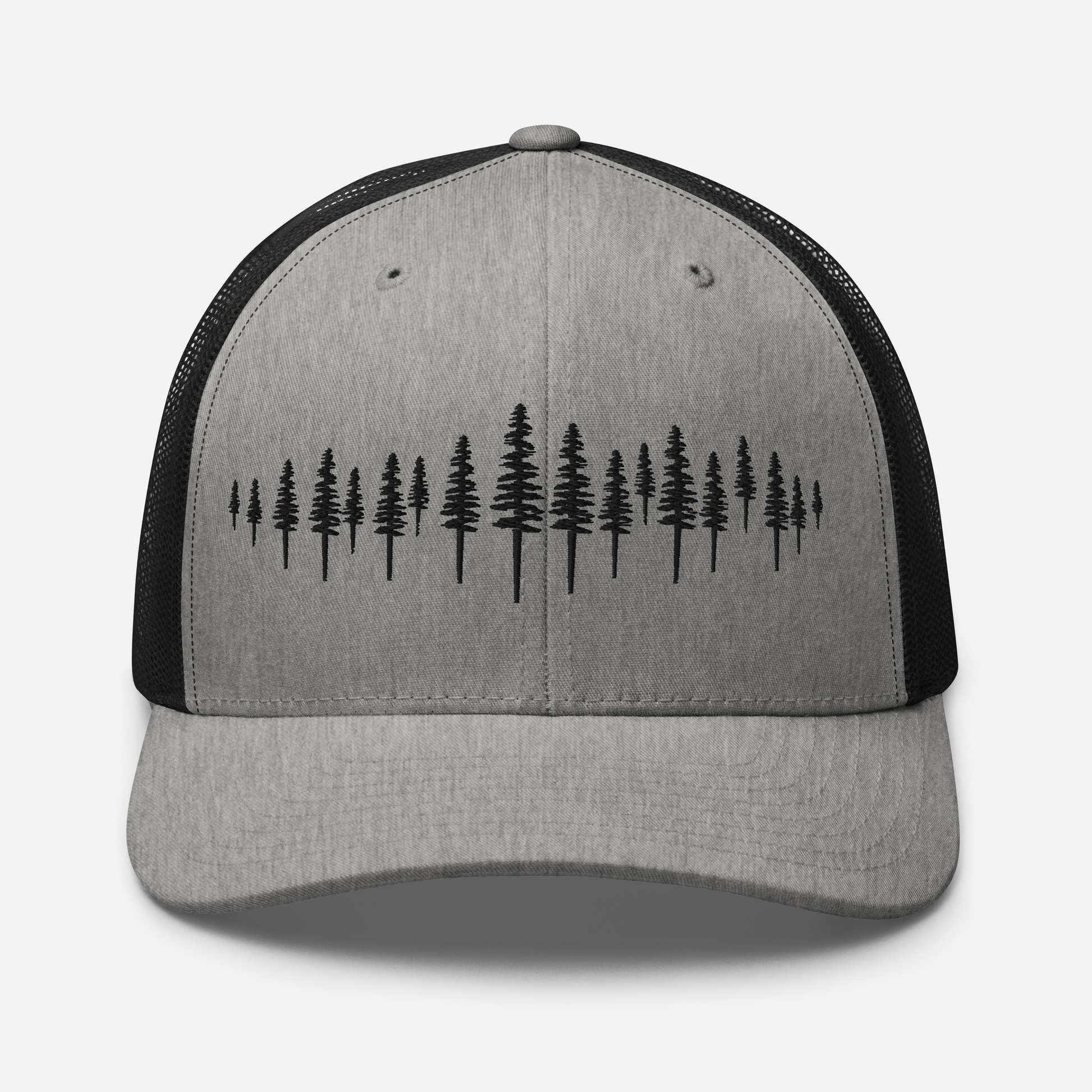 Détail de la broderie forêt de sapins sur casquette trucker Sortie Longue heather et noir, motif simple évoquant le parcours en sous-bois.