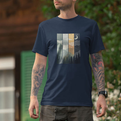 T-shirt unisexe Sortie Longue porté en extérieur devant une maison en bois, visuel illustré représentant différentes conditions de progression avec forêt, relief et variations de lumière.